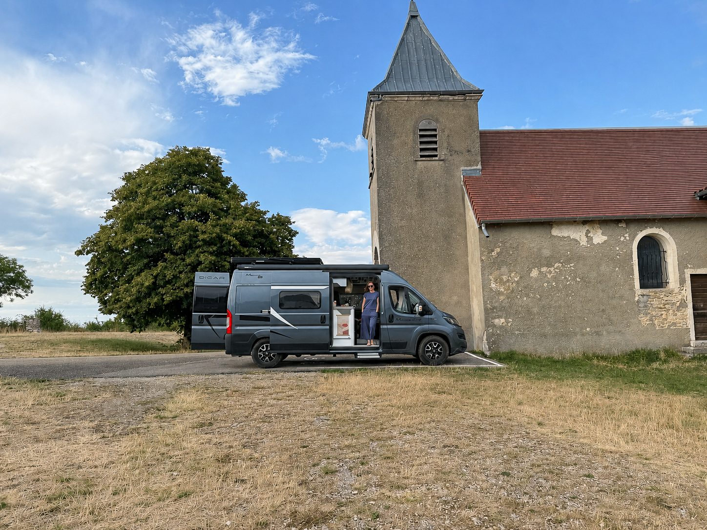 Camper Freddy naast een oud Frans dorpskerkje